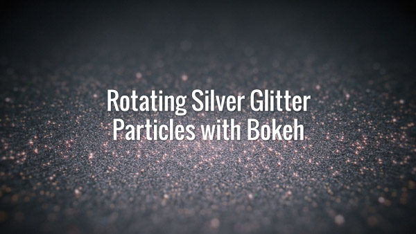 Seamlessly looping rotating shiny silver particles with bokeh