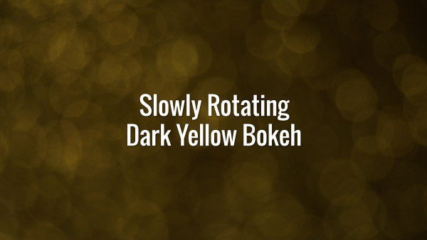 Seamlessly looping spinning flickering dark yellow glitter particles on dark surface.