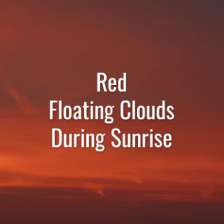 Time-lapse video of slowly floating peculiar orange and red clouds getting brighter during the sunrise